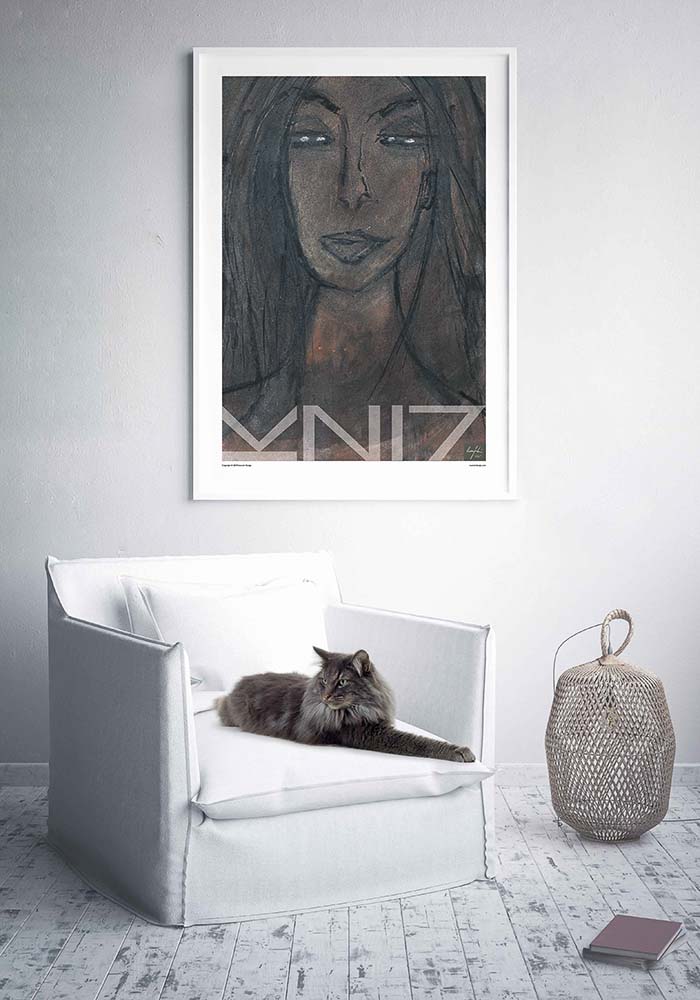 Picture of a cat in armchair and a large framed art print on the wall