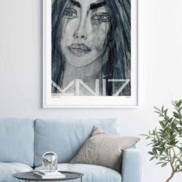 Light blue sofa with a large portrait art print on the wall and a green plant in a pot beside.