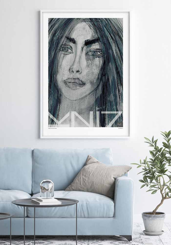 Light blue sofa with a large portrait art print on the wall and a green plant in a pot beside.
